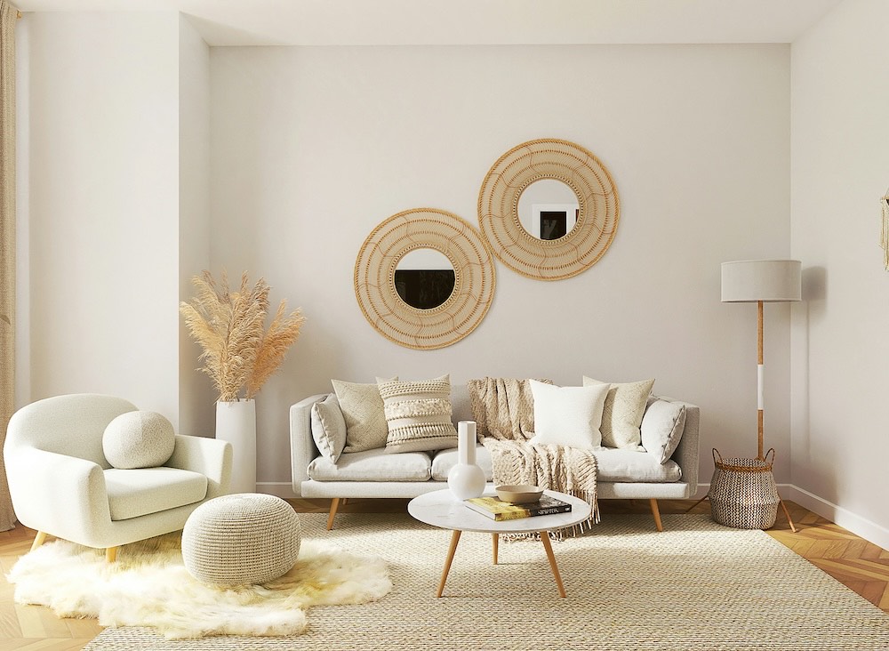 A bright living room with white walls and a white sofa